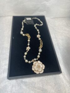 gold and pearl long necklace with flower detail
