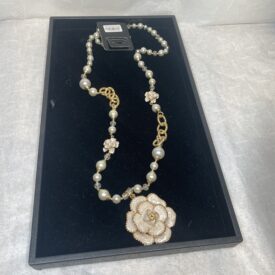 gold and pearl long necklace with flower detail